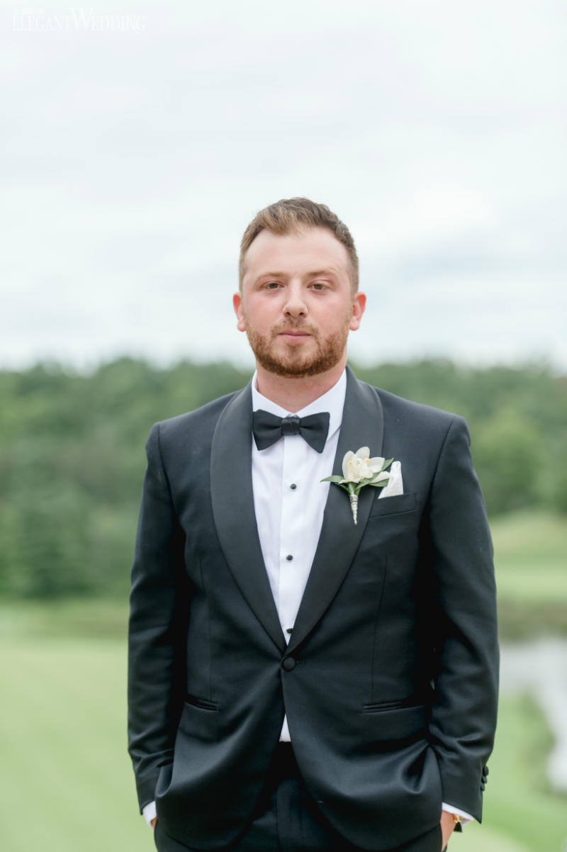 blush pink wedding inspiration elegant wedding18 groom in a black tuxedo