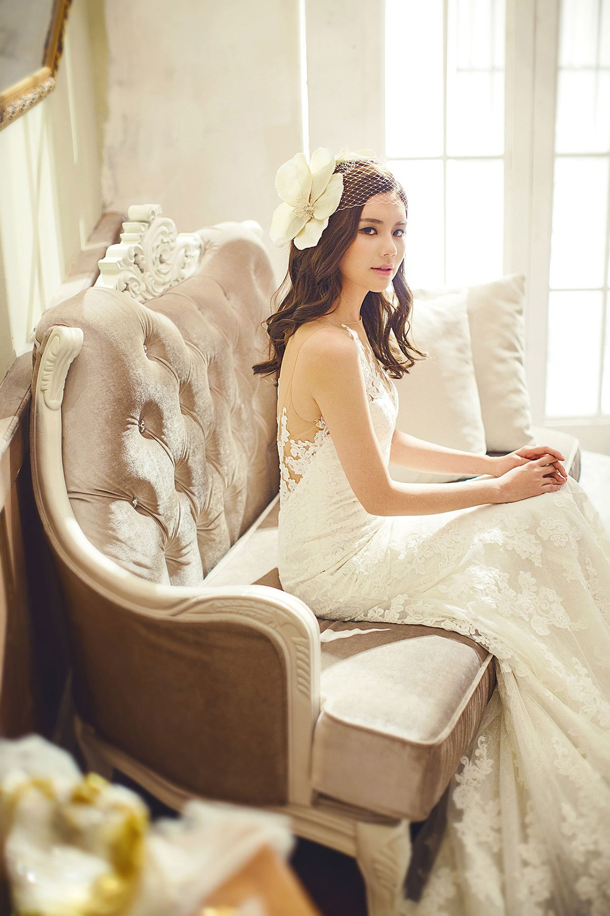 BRIDE-THAT-IS-A-STUDENT-PLANNING-A-WEDDING bride sitting on a sofa
