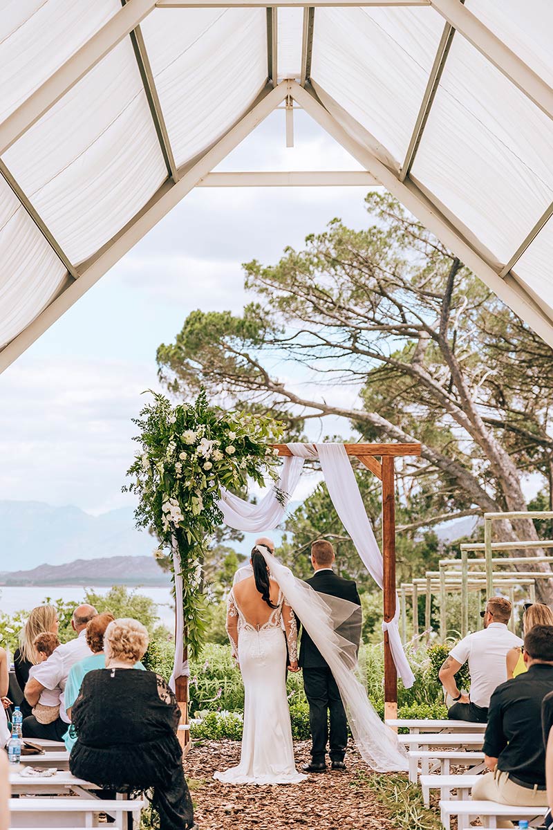 WEDDING-CEREMONY-FOR-STUDENTS-GETTING-MARRIED wedding ceremony with a wooden arch
