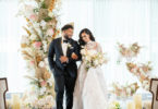 bride and groom in a gold and white ceremony theme