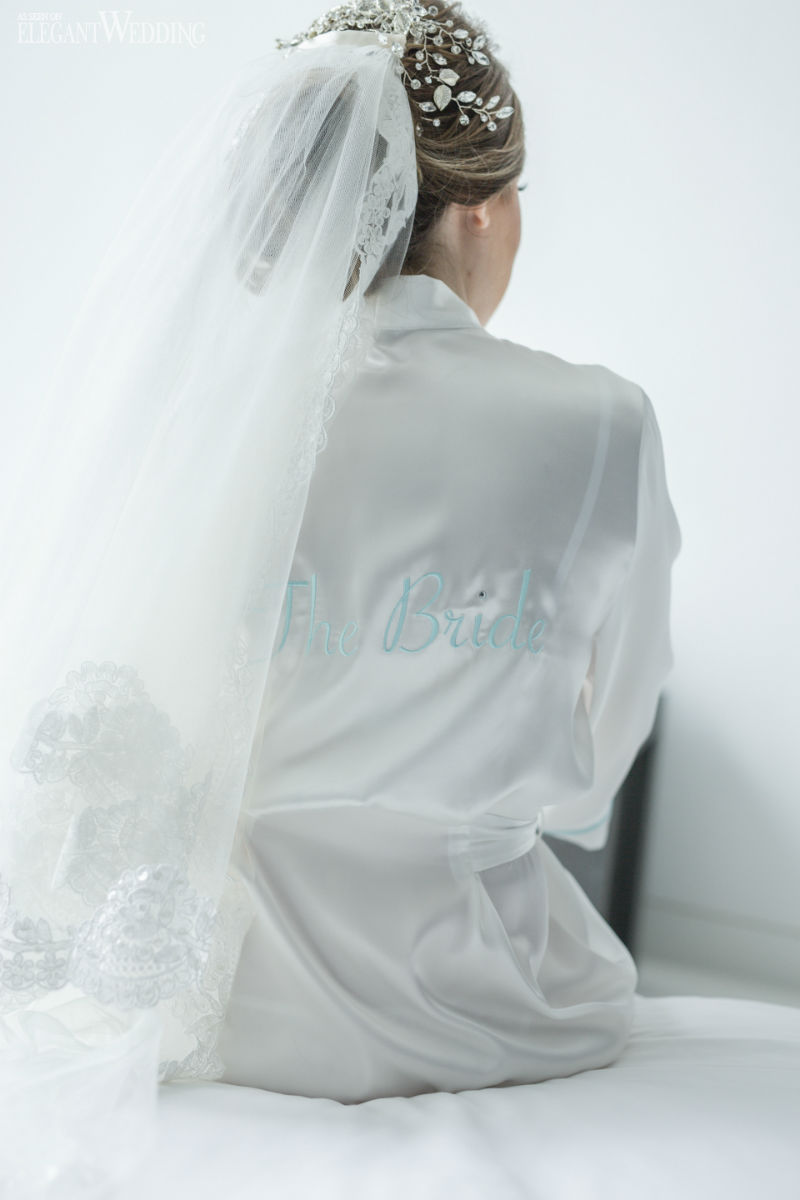 ultimate prep guide for a bride3 bride in a white robe getting ready