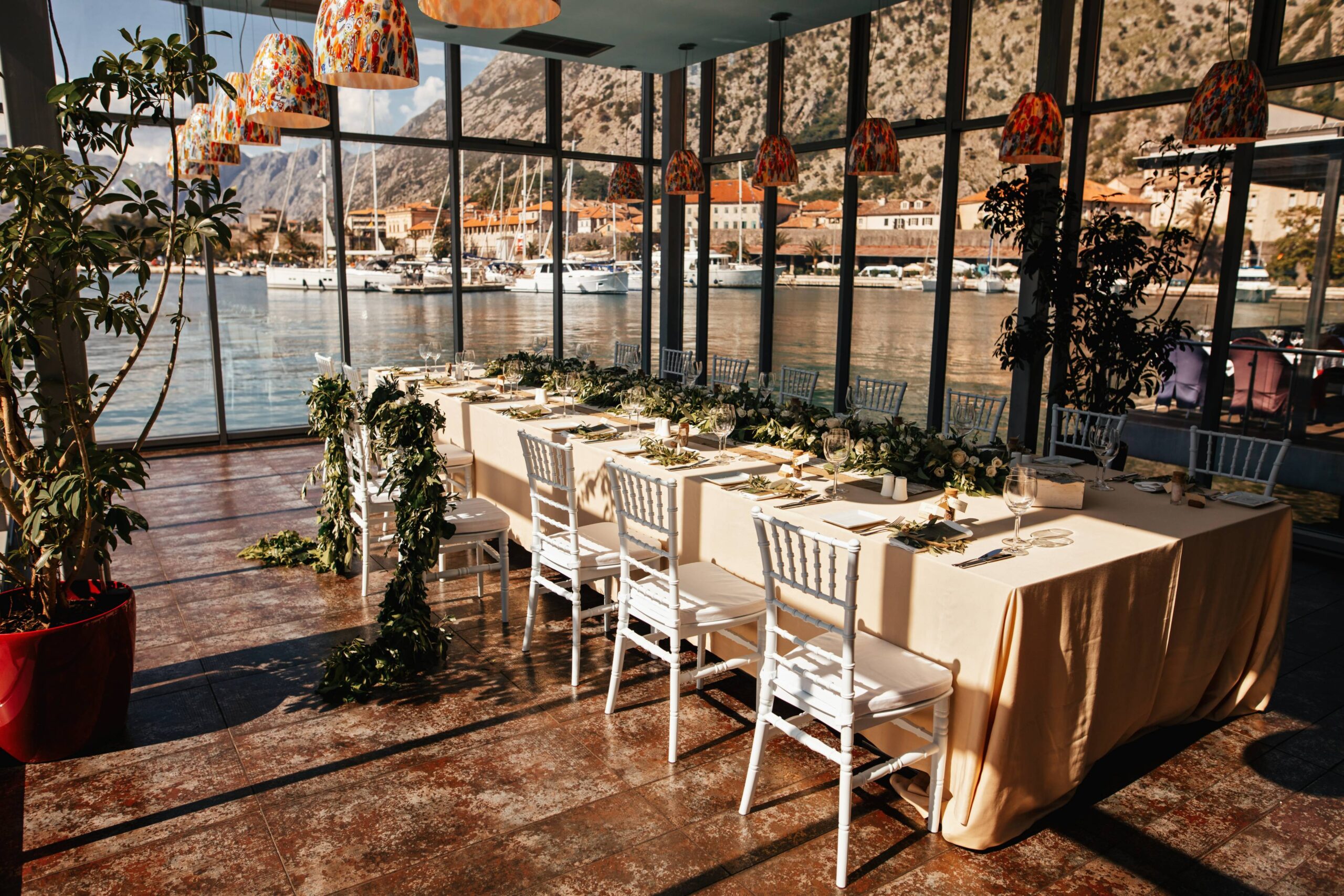 wedding-reception-room-with-decorated-table-setting-sea-view-through-window wedding venue with a view