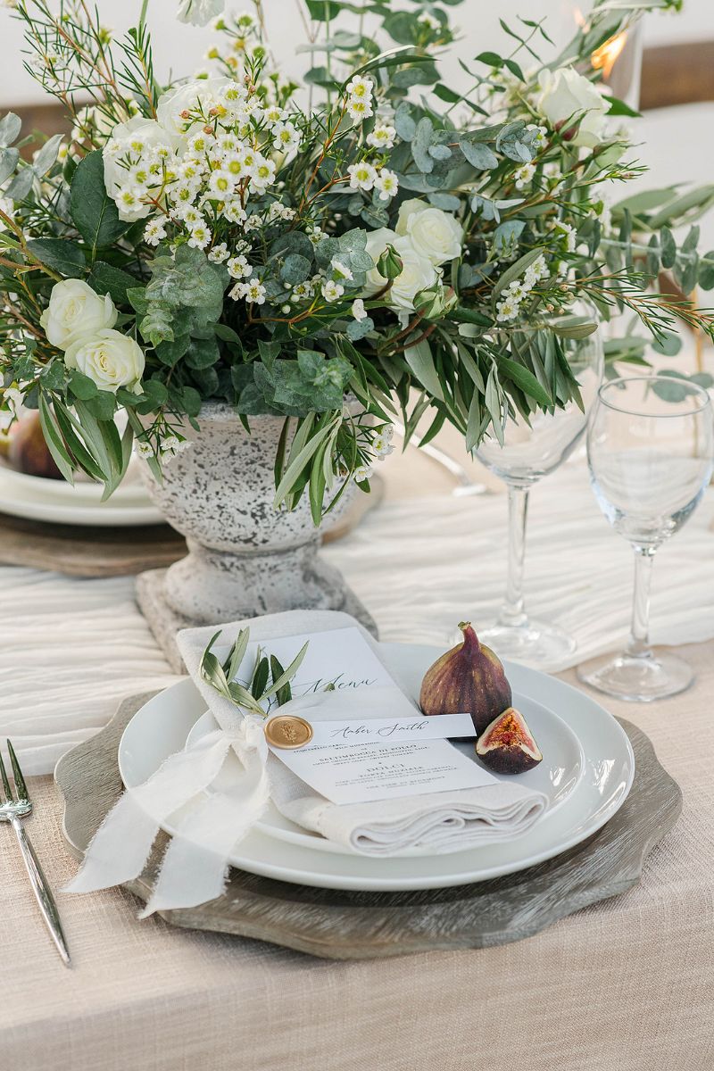 Pretty table setting with a fig, green and white