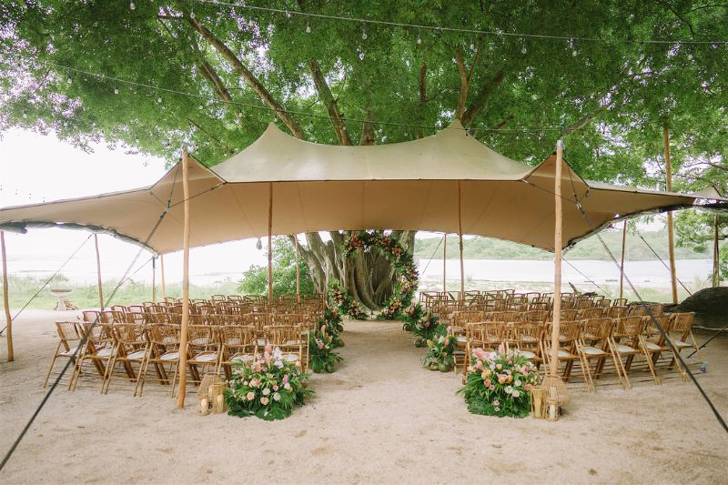 tropical wedding tent ceremony by the beach